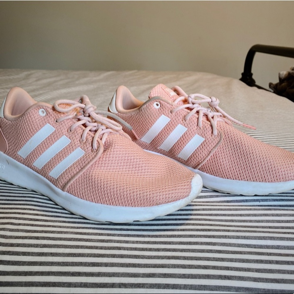 Coral colored adidas cloud foam running shoes.
